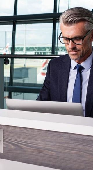 A Passenger Working in the Aspire Airport Lounge in London Heathrow Airport Terminal 5