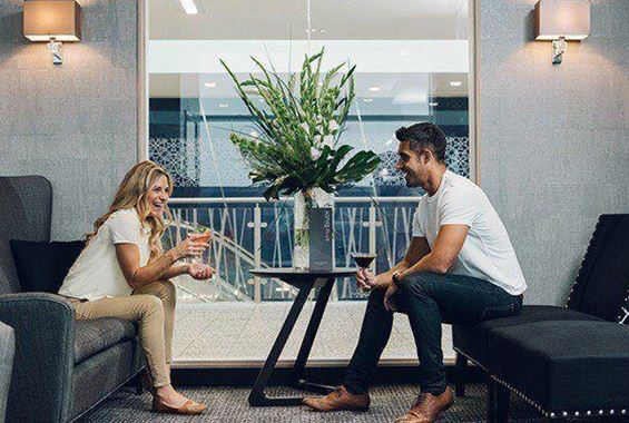 Woman and man enjoying cocktails together